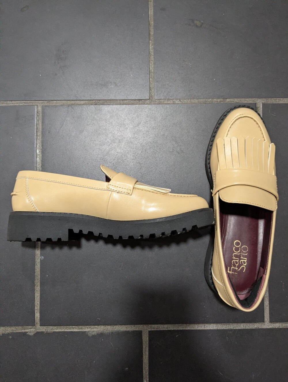 cream loafers with fringe and supportive black bottoms